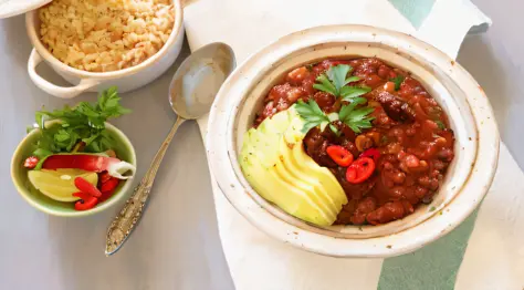 bowls of food on a table with a spoon, spoon, and spoon rest, chili, yummy, overflowing with baked beans, baked beans, profile i...