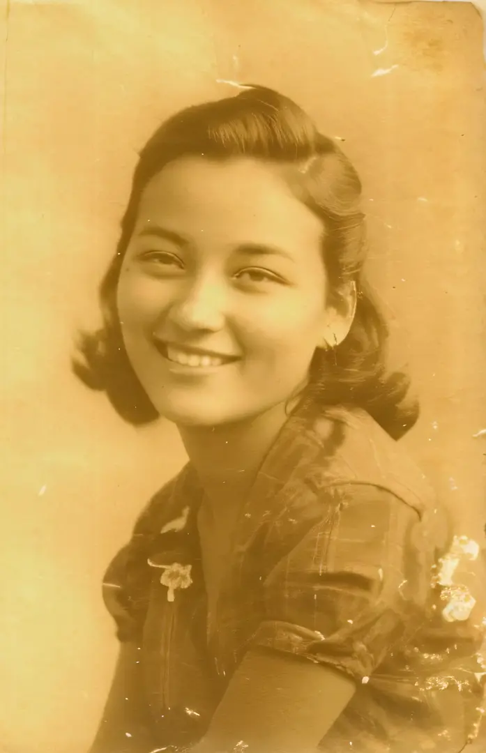 An old photo of a woman with a smile on her face, in her early 20s, photo of young woman,  A young Asian woman