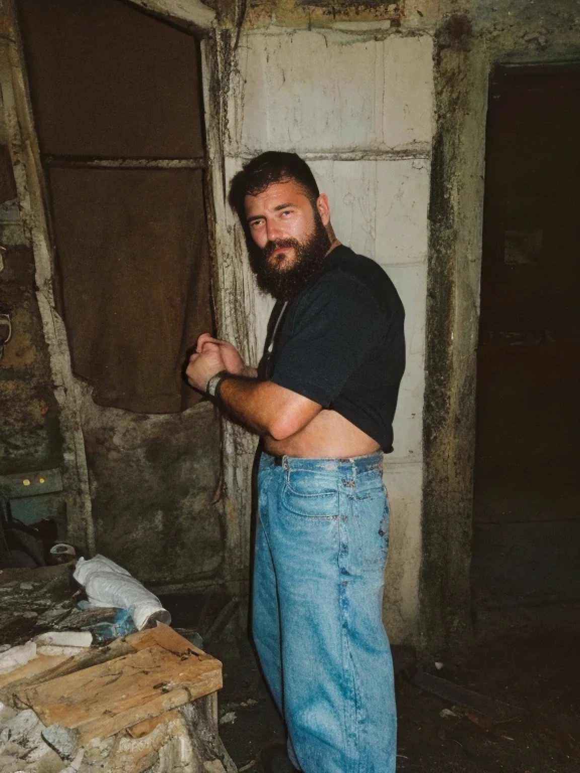 Arafed man in a black shirt and jeans holding a knife - SeaArt AI