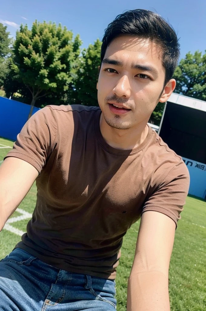 ((realistic daylight)) , Young Korean man in a simple brown t-shirt only, no pattern, denim shirt, and jeans., A handsome, muscular young Asian man looks at the camera.  , in the football field ,turn sideways