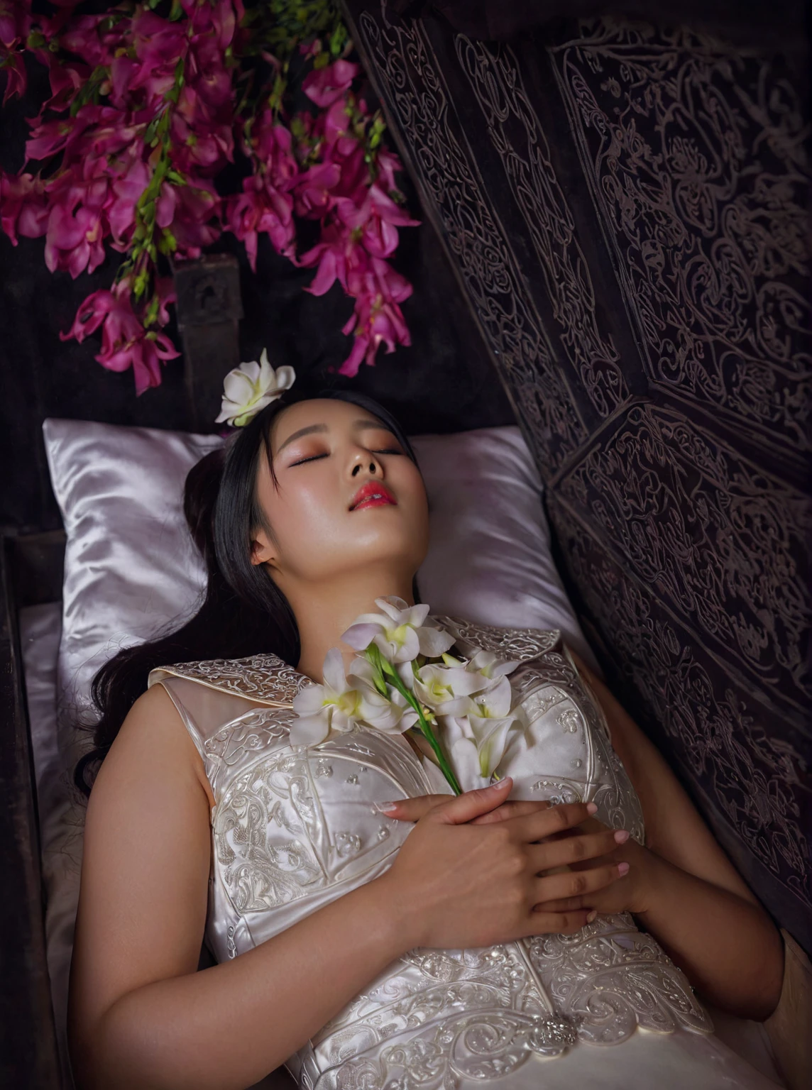 In a striking 8K HDR scene, a stunning Korean woman, 22 years old, lies peacefully in a coffin and coffin cover surrounded by plush pillows behind head. The deep box is set against a rich black background, accentuating the beauty of the subject. Her exquisite deep-V neckline kebaya attire is embroidered with superb detail, showcasing her round and firm breasts, perfect cleavage, and beautiful eyebrows. Her closed eyes and mouth give an air of serenity, while her visible and absolute cleavage leave nothing to imagination. The scene is bathed in saturated colors, highlighting every intricate aspect from the ball skirt to her clean face, straight body, detailed hand perfect hands, straight body, own hands together, own hand on stomach, detailed hands, perfect hands, holding the flowers.