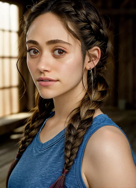 a close up of a woman with a braid in a blue shirt