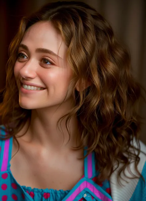 araffed woman with curly hair and a blue shirt smiling