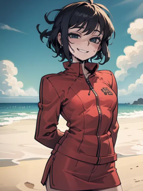 a woman in a red jacket standing on a beach next to the ocean