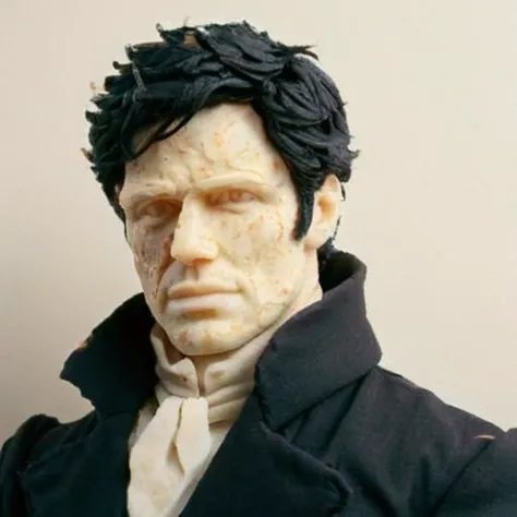 a close up of a statue of a man with a black coat