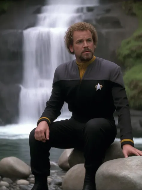 arafed man in uniform sitting on a rock next to a waterfall