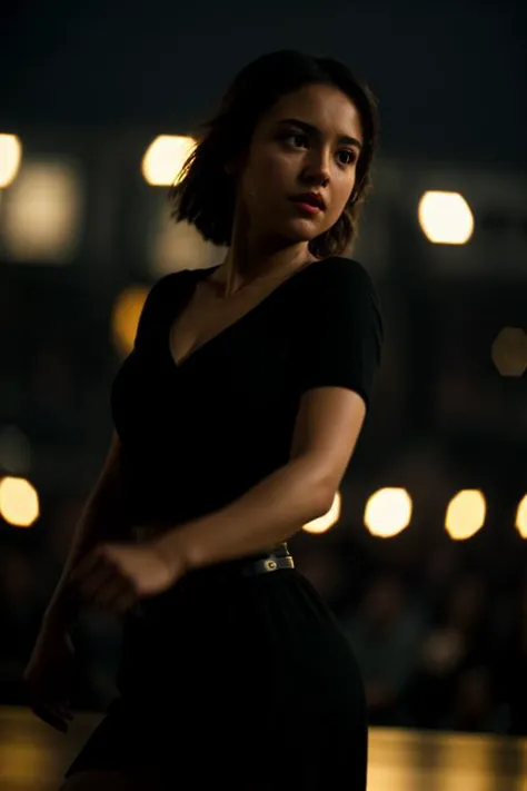 a woman in a black dress is dancing in a dark room