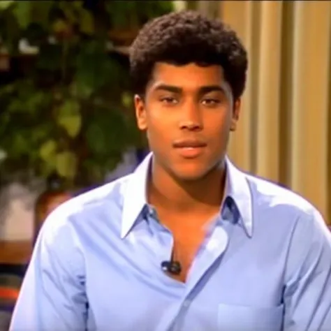 a close up of a person in a blue shirt and a plant