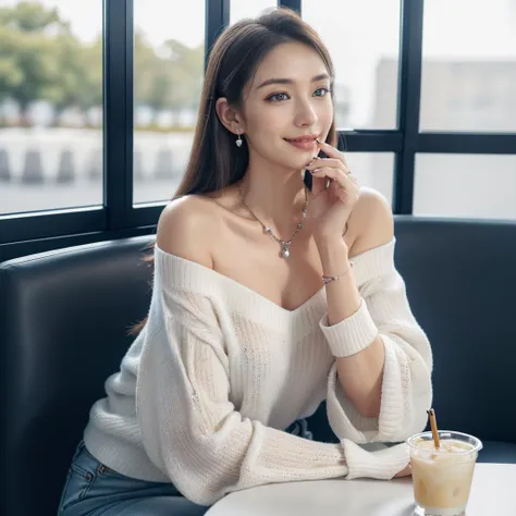 a woman sitting at a table with a drink and a cell phone