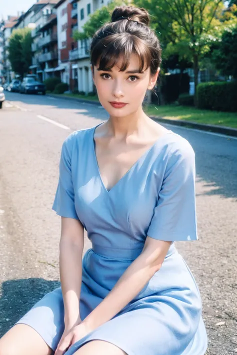 a woman sitting on the ground in a blue dress