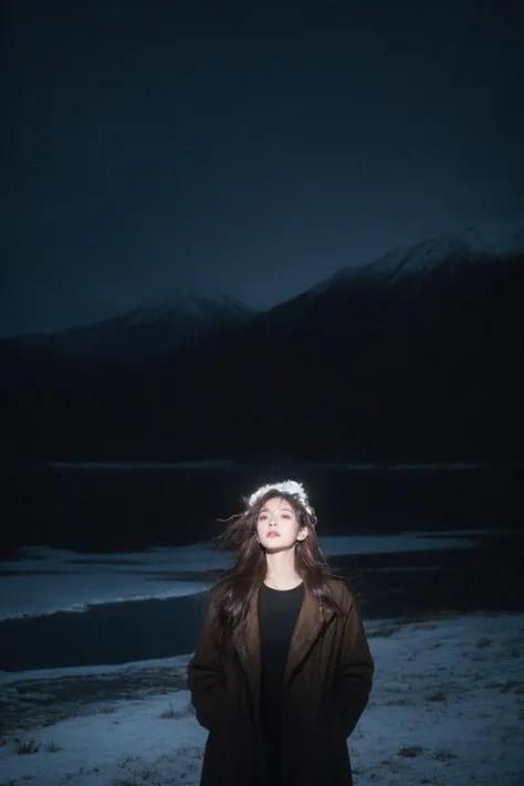 a woman standing in the snow with a mountain in the background