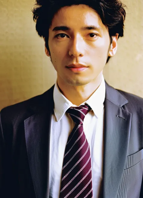 arafed man in a suit and tie standing in front of a wall