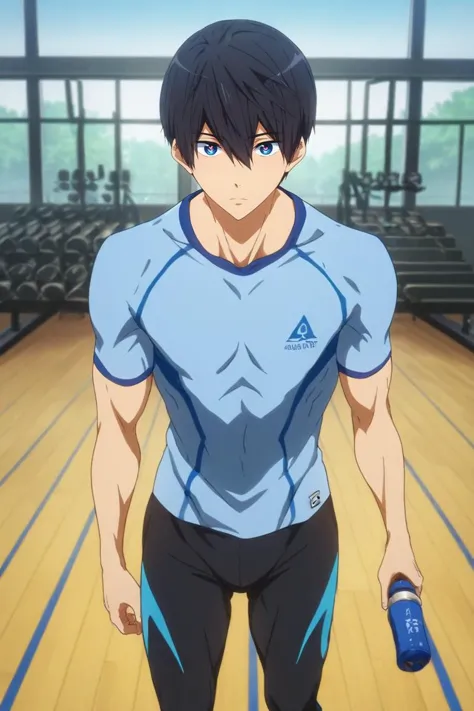 a man in a blue shirt and black pants standing in a gym