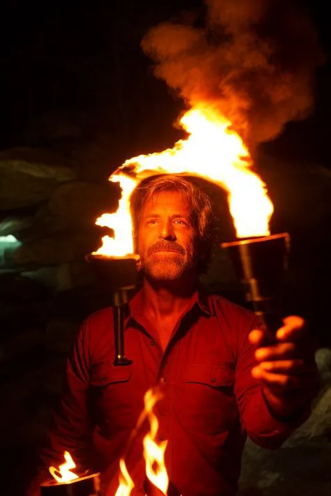 a man holding a lit up fire stick in his hand