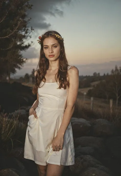 a woman in a white dress standing on rocks with a flower crown