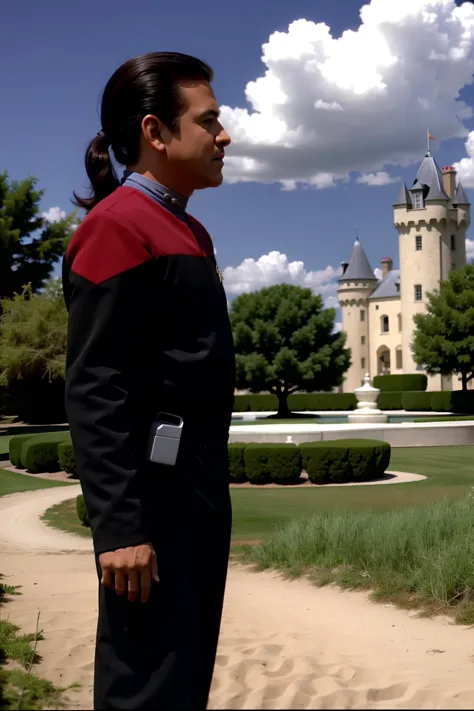 there is a man standing in front of a castle with a clock tower